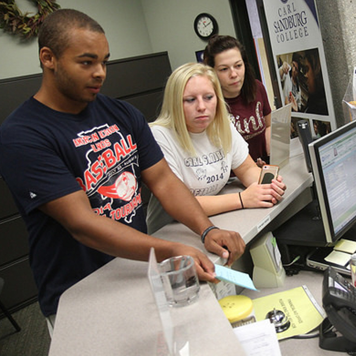 students standing at the financial aid office desk.